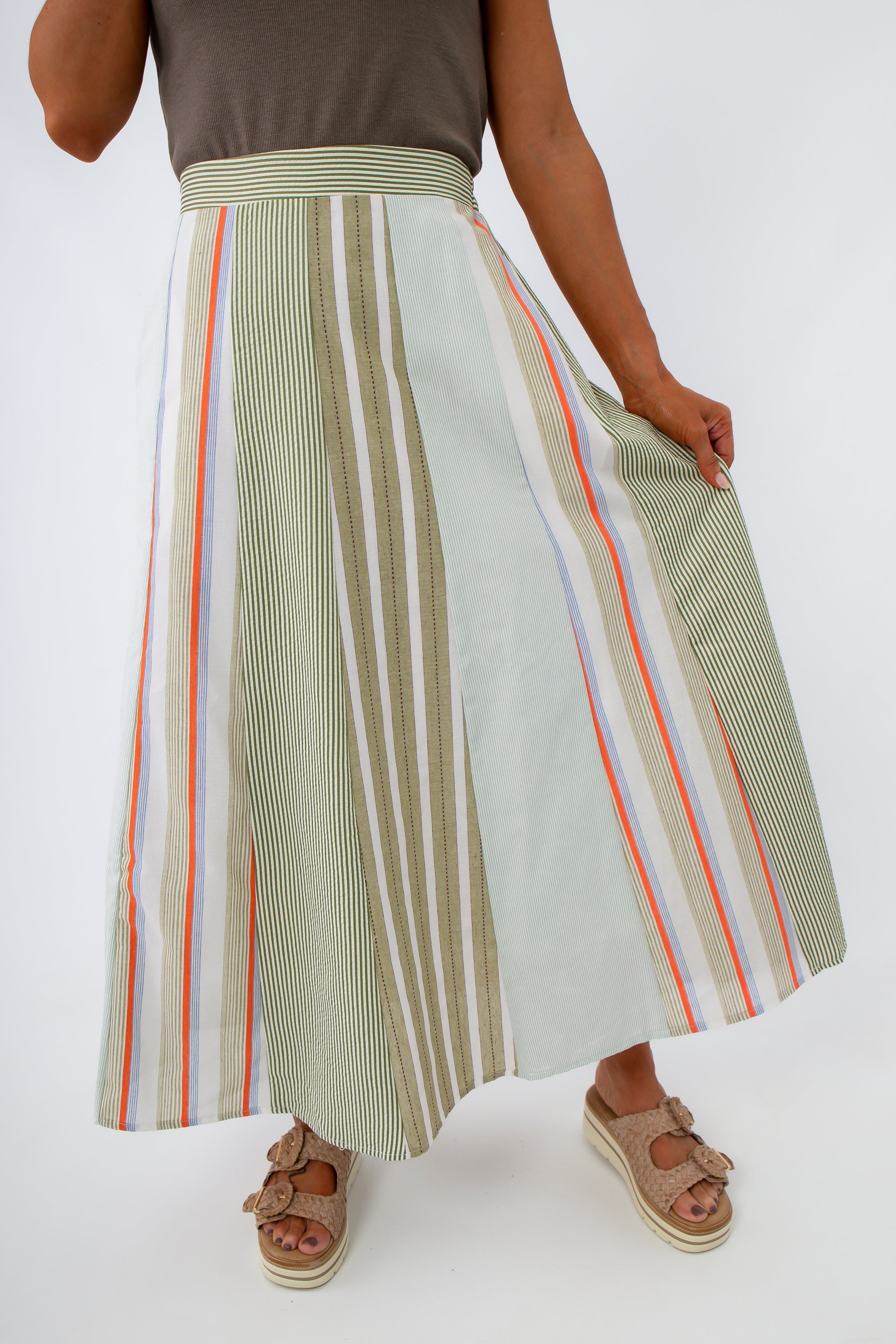 close-up of striped midi skirt with green, orange, and white vertical lines