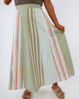close-up of striped midi skirt with green, orange, and white vertical lines