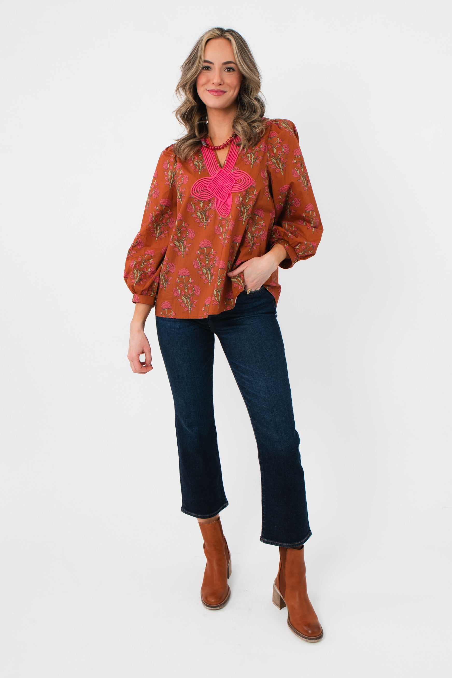Full view of Carmen Rust Floral Embroidered Blouse – Balloon Sleeve V Neck, paired with cropped jeans and brown boots for fall fashion.