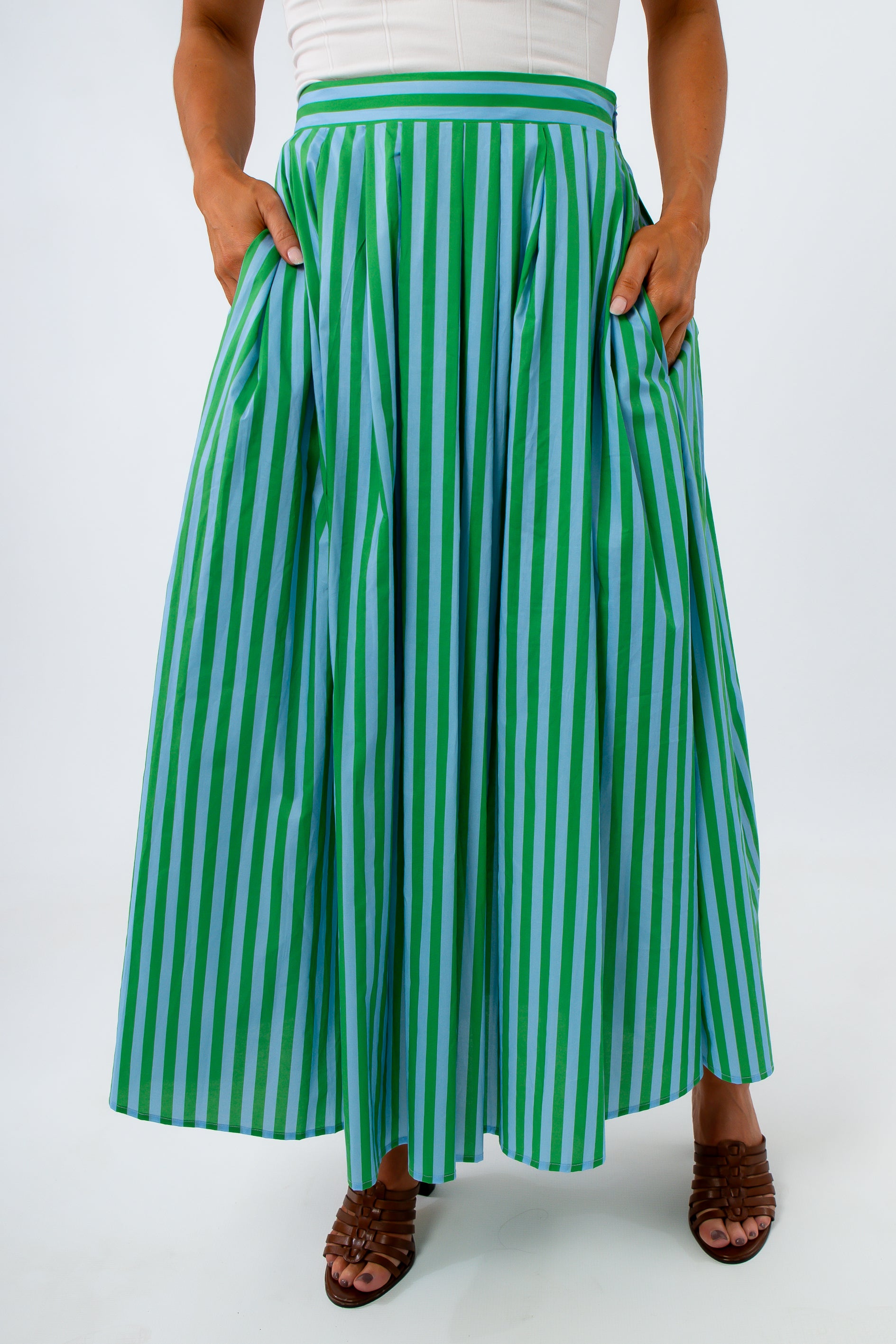 Close-up of green and blue striped midi skirt with side pockets and pleats