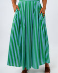 Close-up of green and blue striped midi skirt with side pockets and pleats