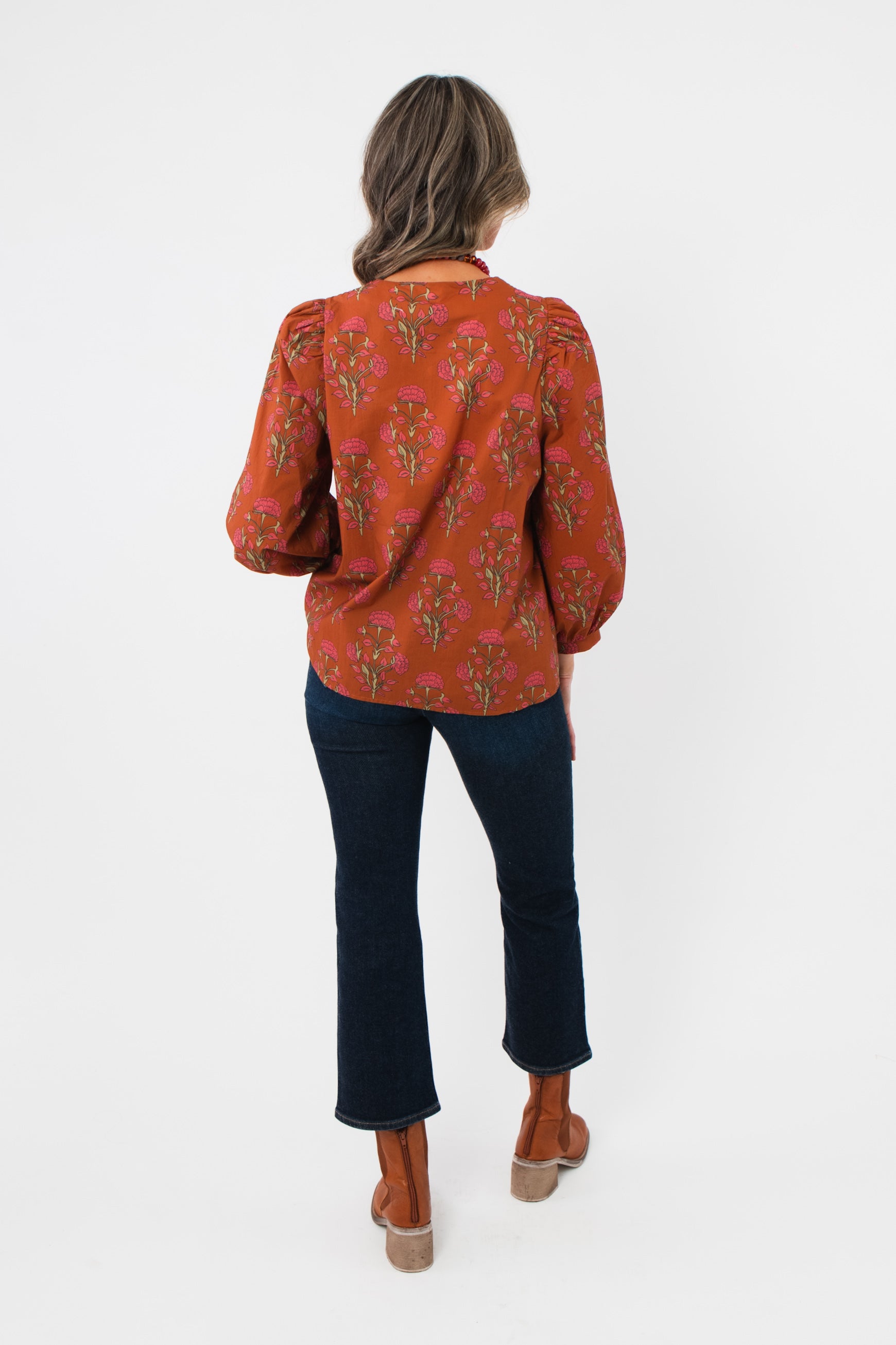 Back view of Carmen Rust Floral Embroidered Blouse showing floral print and relaxed fit, ideal for layering in fall wardrobes.