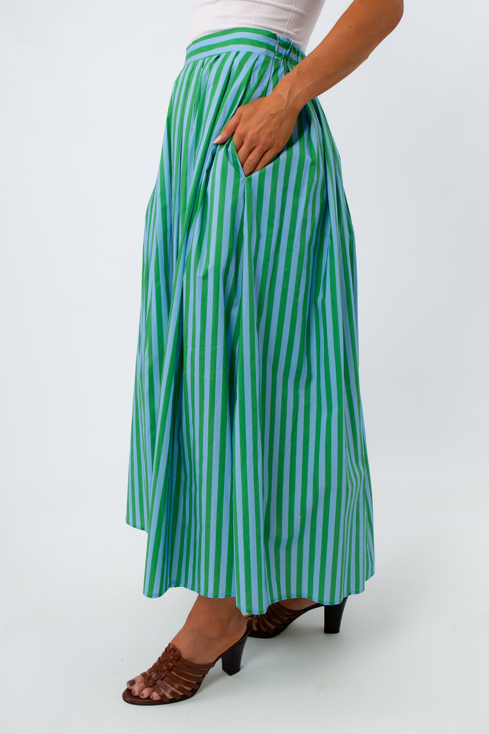 Green and blue striped midi skirt with pleats and elastic waist, worn with white top
