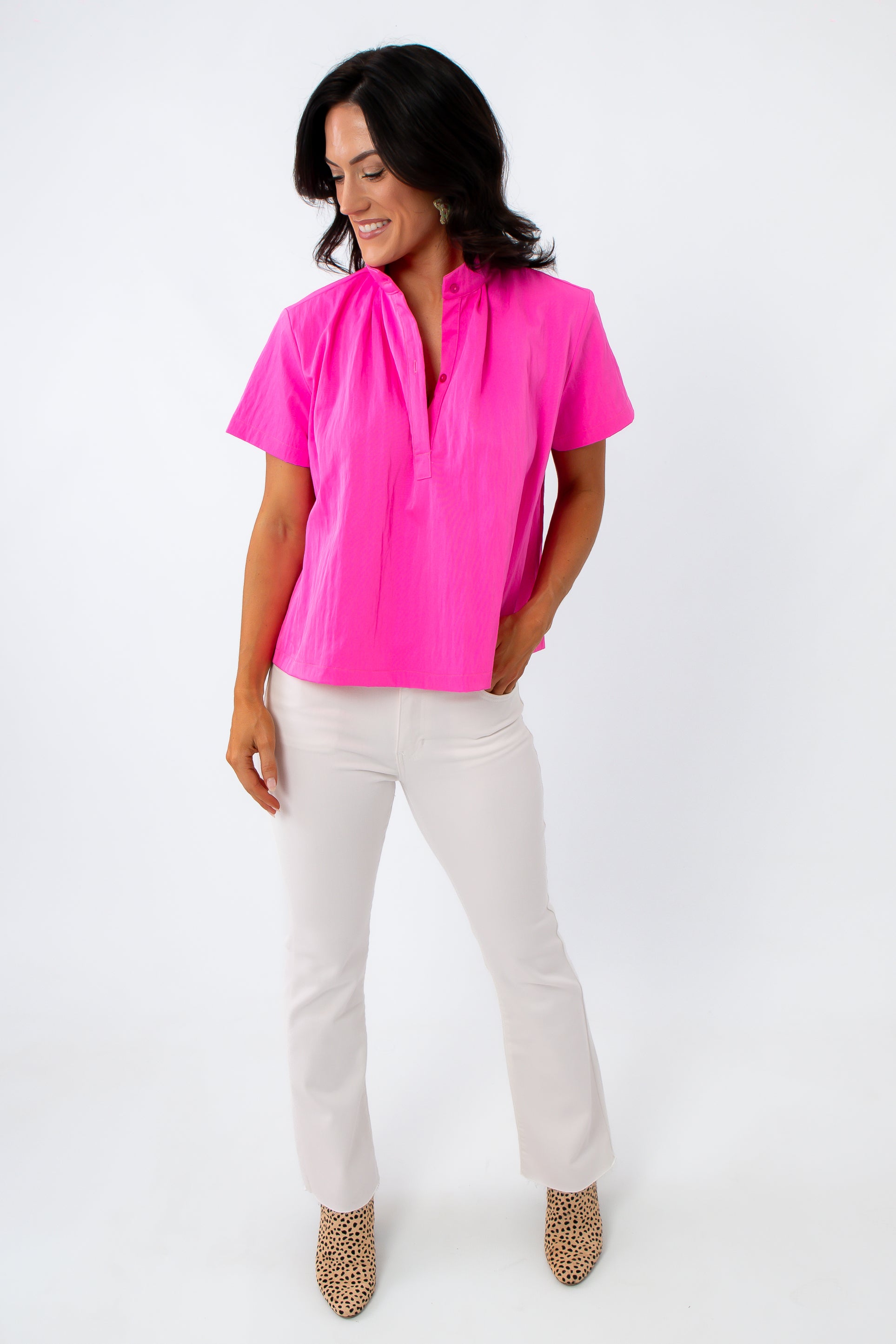 Bright pink short sleeve blouse with structured collar and pintuck back