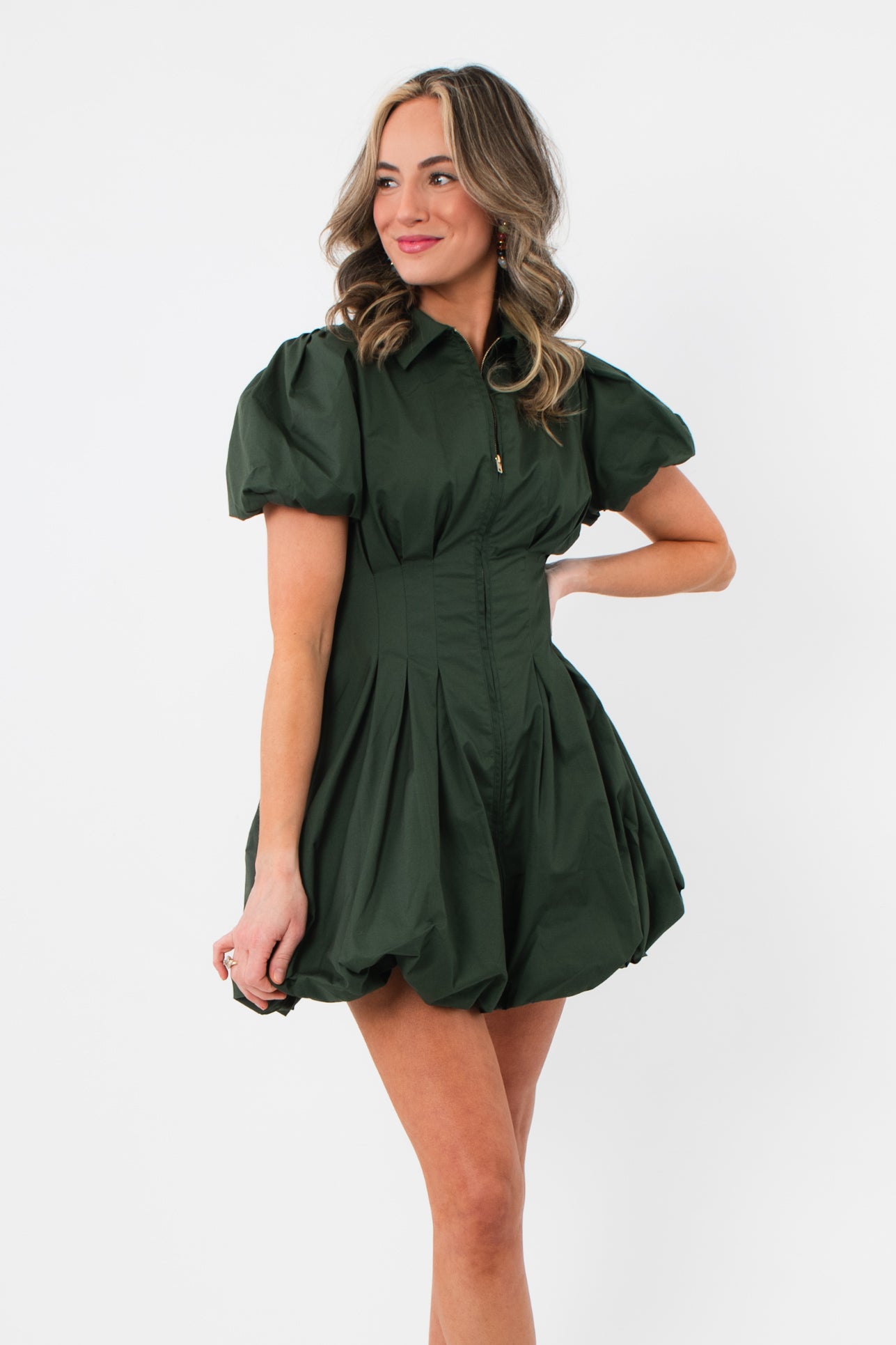 Side view of Arden Hunter Green Bubble Dress showing structured puff sleeves, fitted waist, and voluminous bubble hem design.