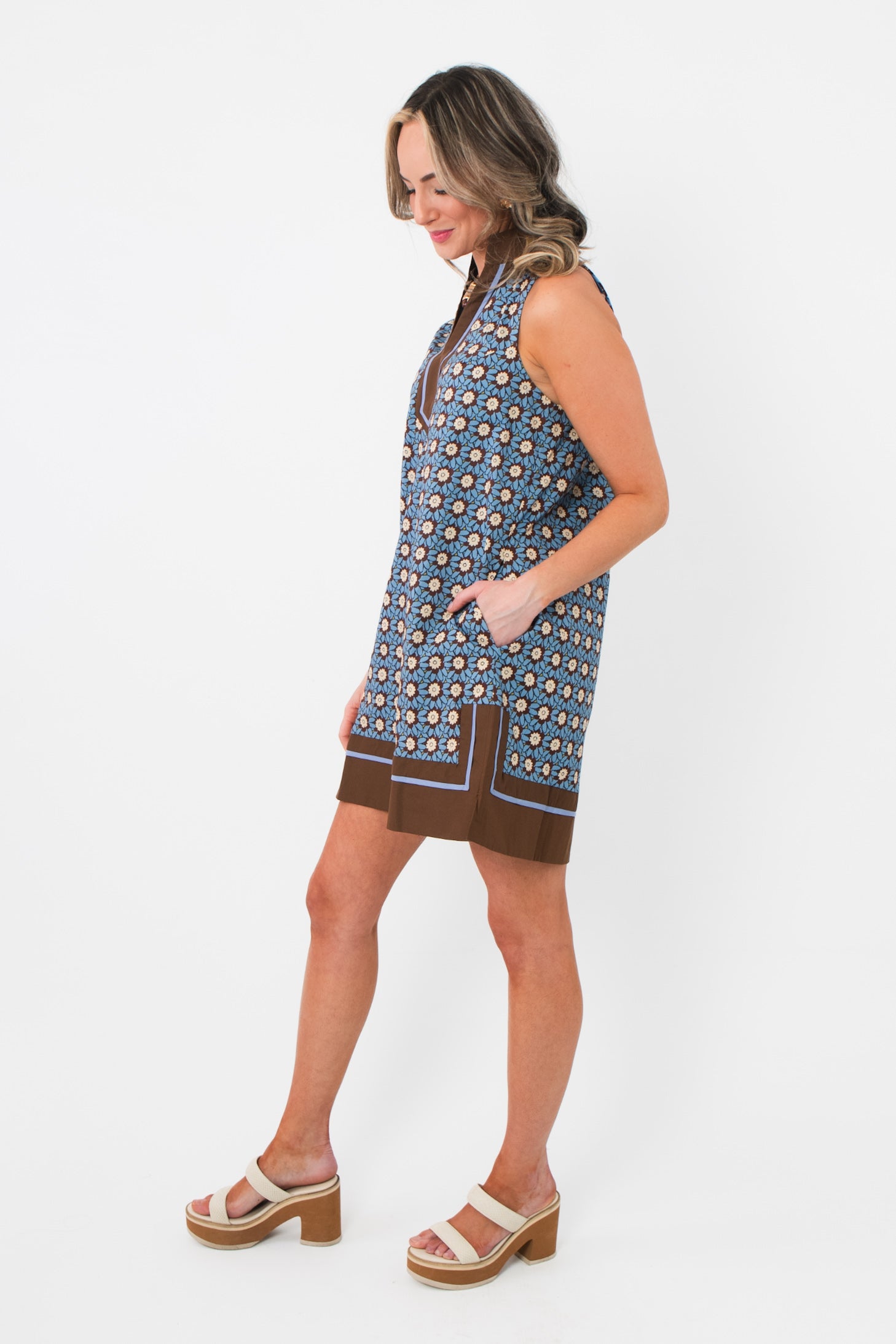 Side view of Maureen Chambray Medallion Shift Dress – Floral Sleeveless V Neck showing relaxed fit and brown hemline detail.