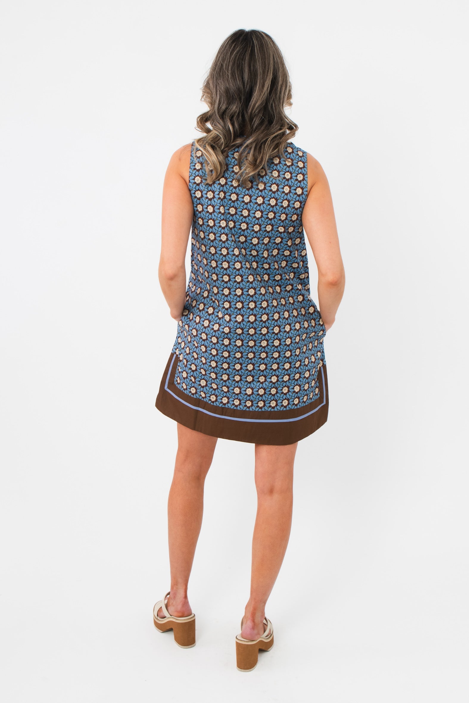Back view of Maureen Chambray Medallion Shift Dress – Floral Sleeveless V Neck with allover medallion print and brown border trim.