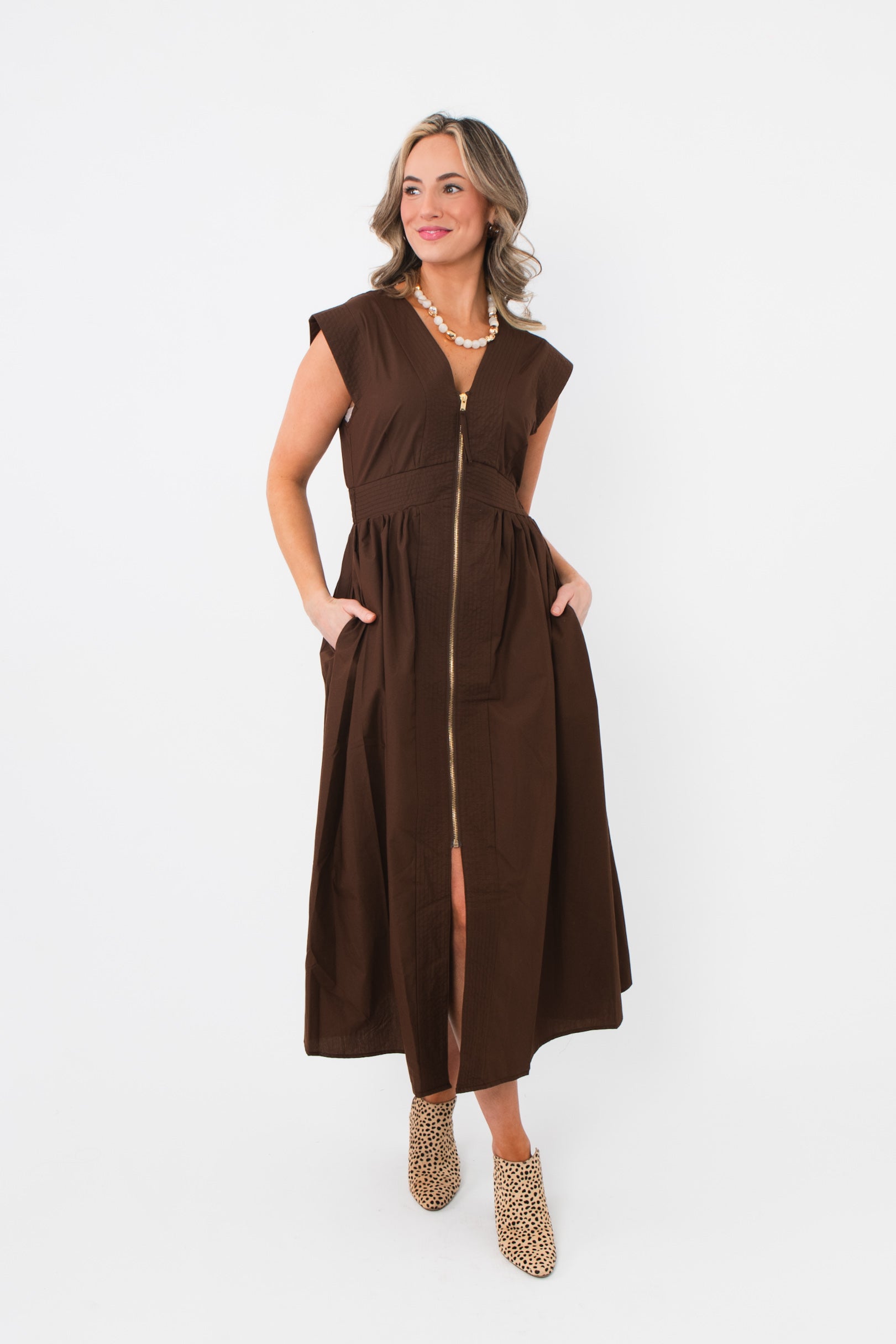 Chic Brownstone Front Zip Sleeveless Midi Dress featuring front pockets and a flattering A-line silhouette, ideal for casual or dressy occasions.