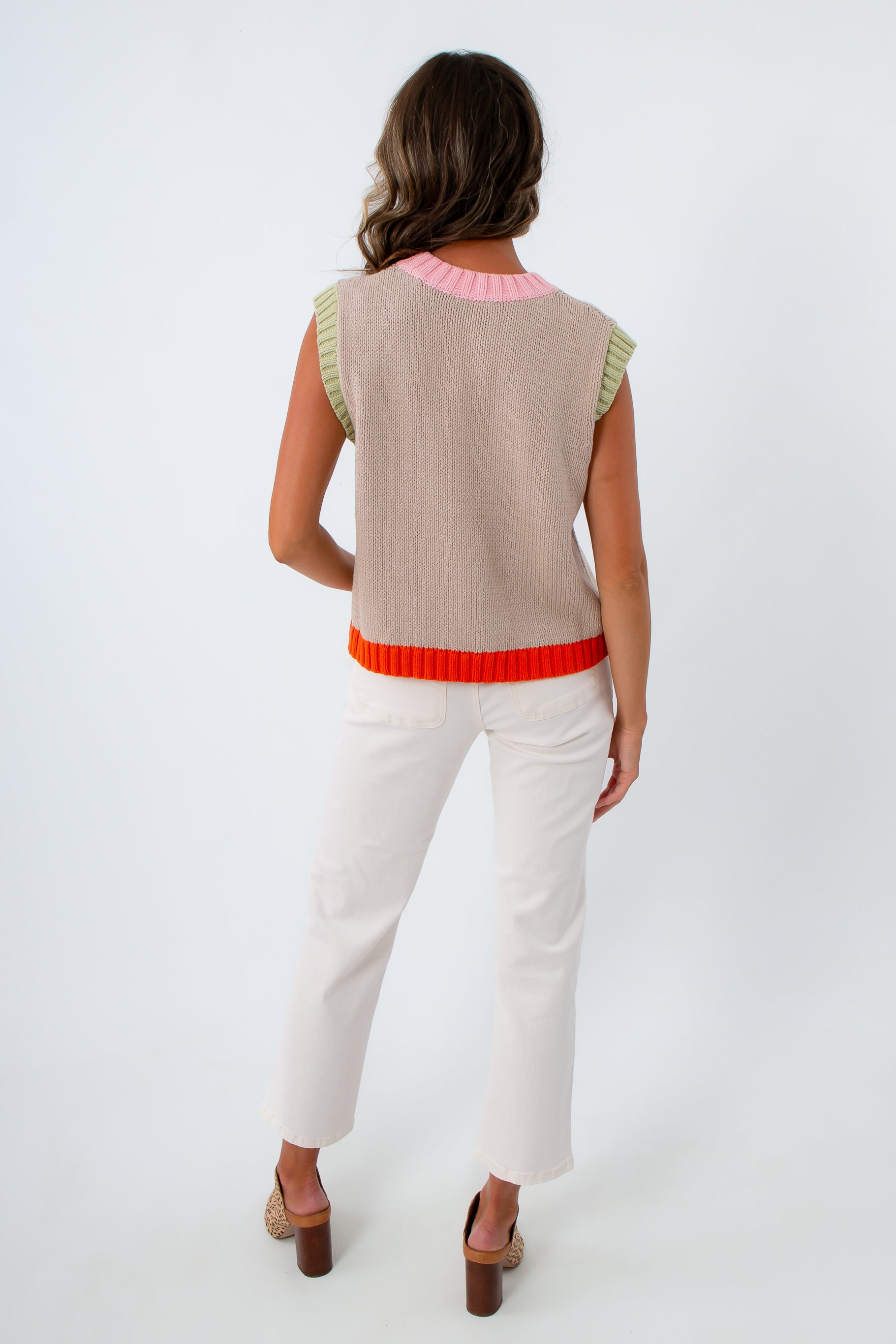 Tan sleeveless sweater with colorful accents, pink and green sweater