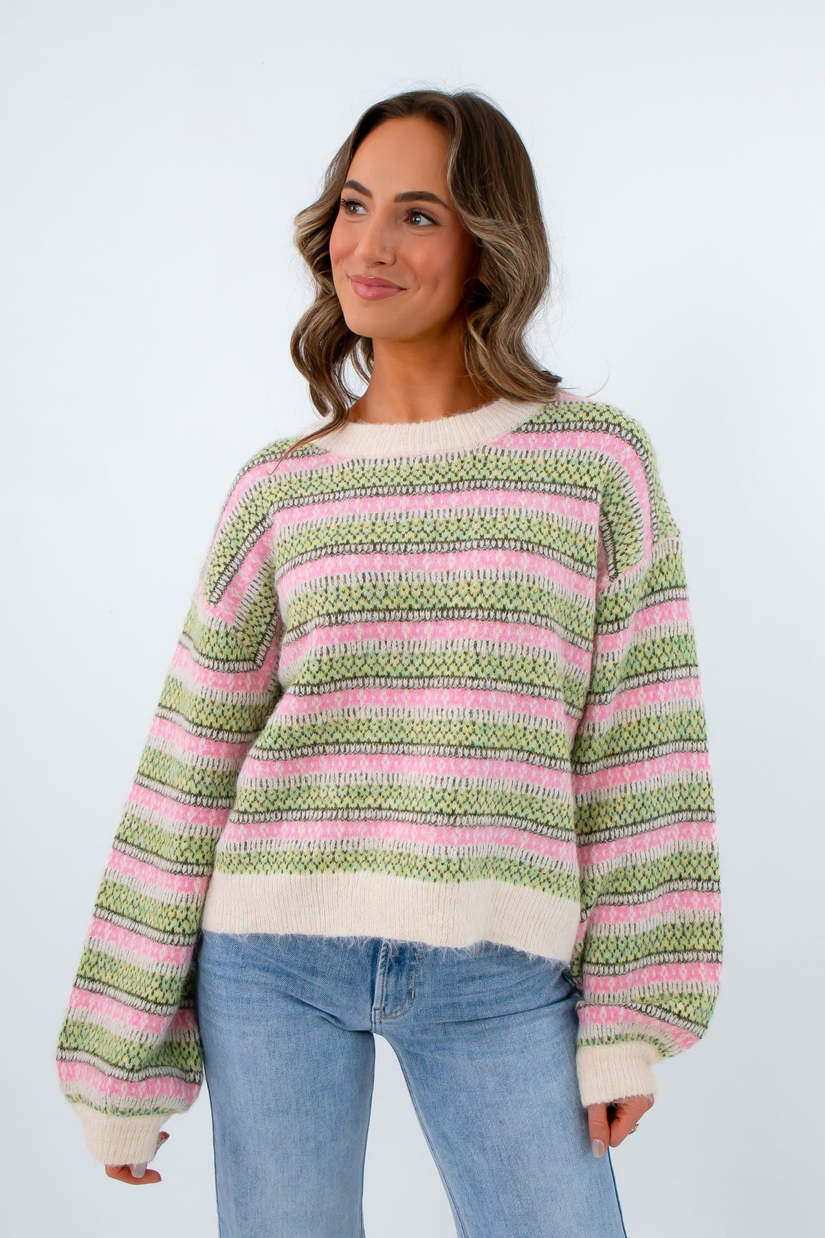 Cozy ivory sweater with pink and green striped design, striped long sleeve sweater