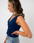 Back view of woman with navy eyelet trim blouse and tied ribbon detail