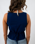 Navy eyelet trim blouse back view with ruffled hem