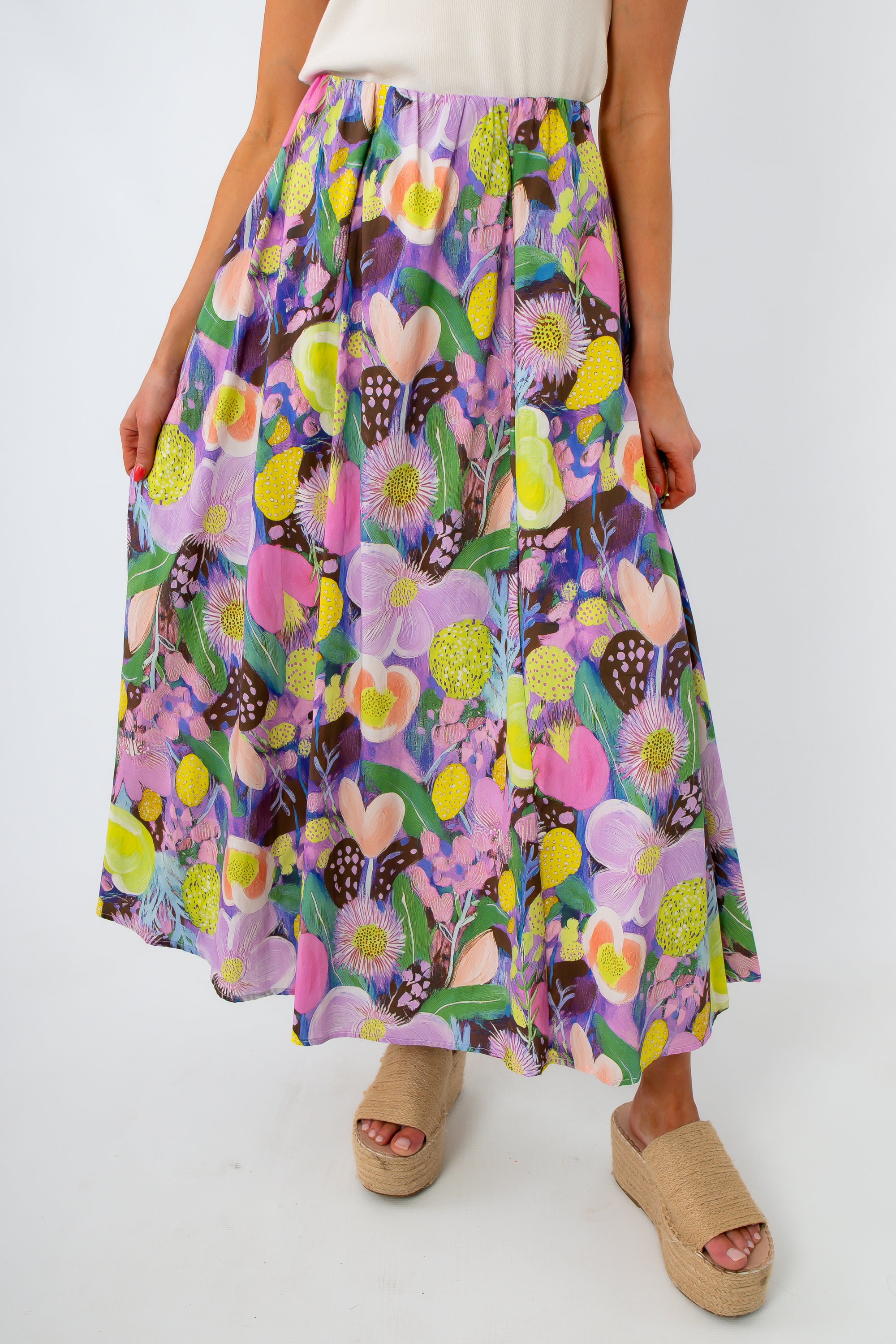 Colorful floral maxi skirt with elastic waist worn by a woman