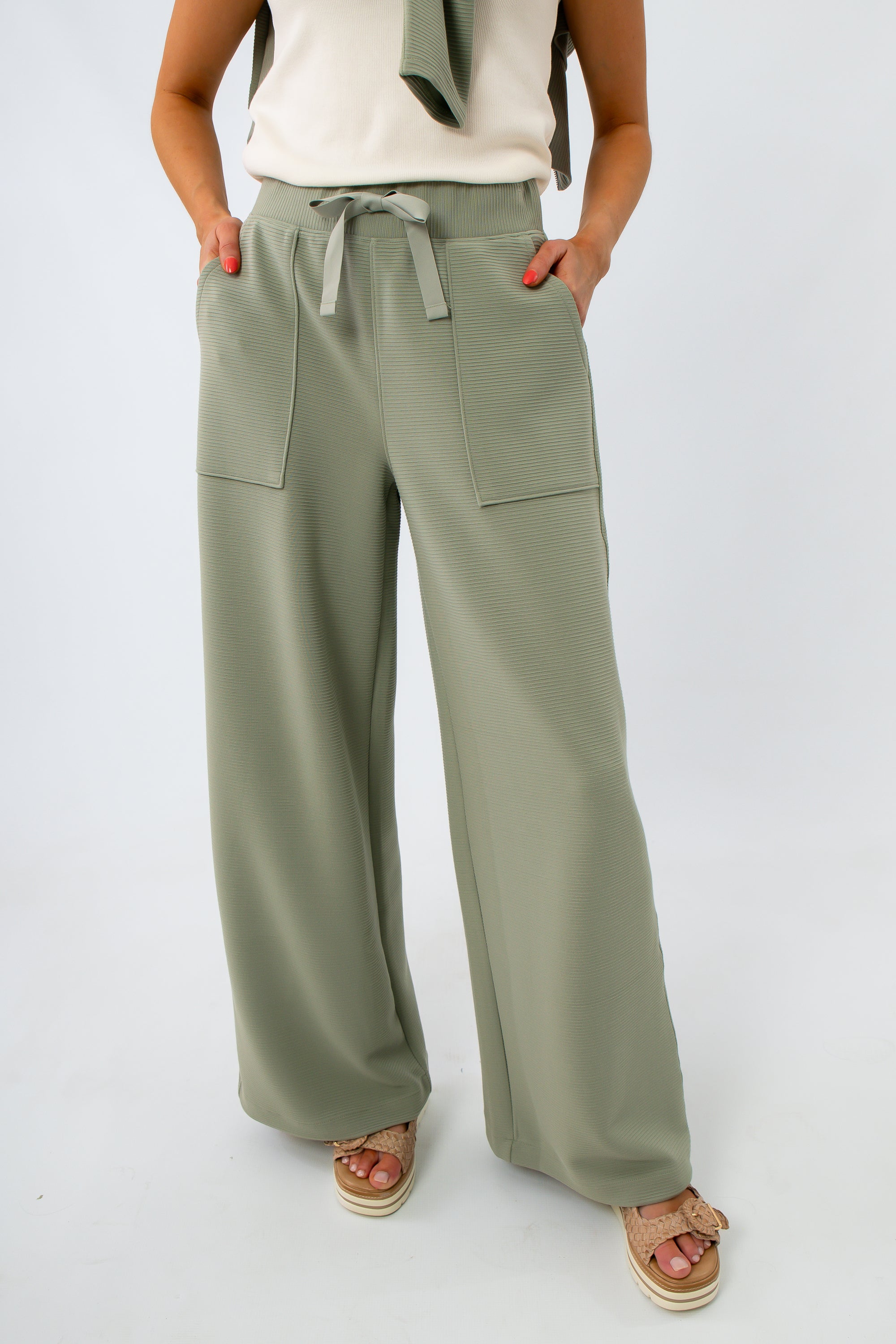 Close-up of women's sage green ribbed lounge pants with drawstring waist