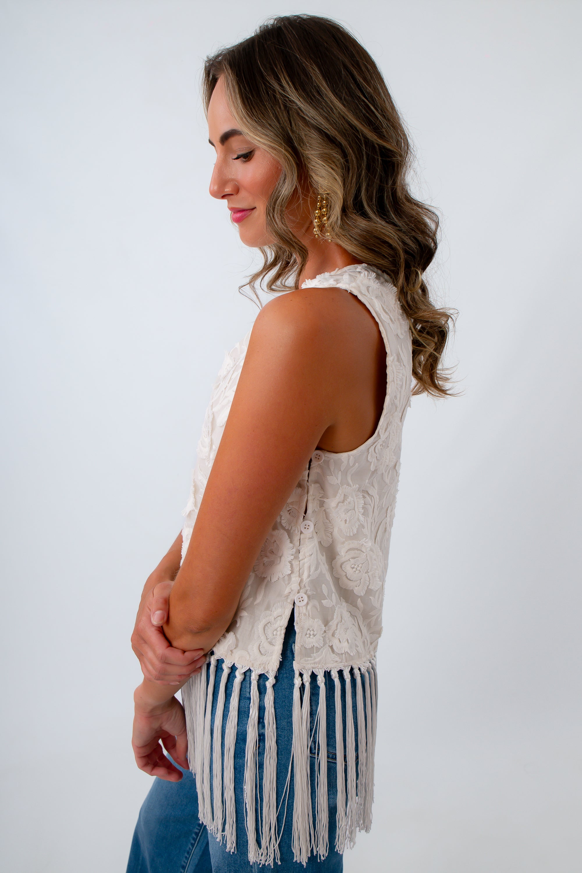 Sleeveless ivory top with side buttons, ivory tops with fringe, ivory tops with embroidered detailing