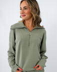 back view of woman in sage green athletic top
