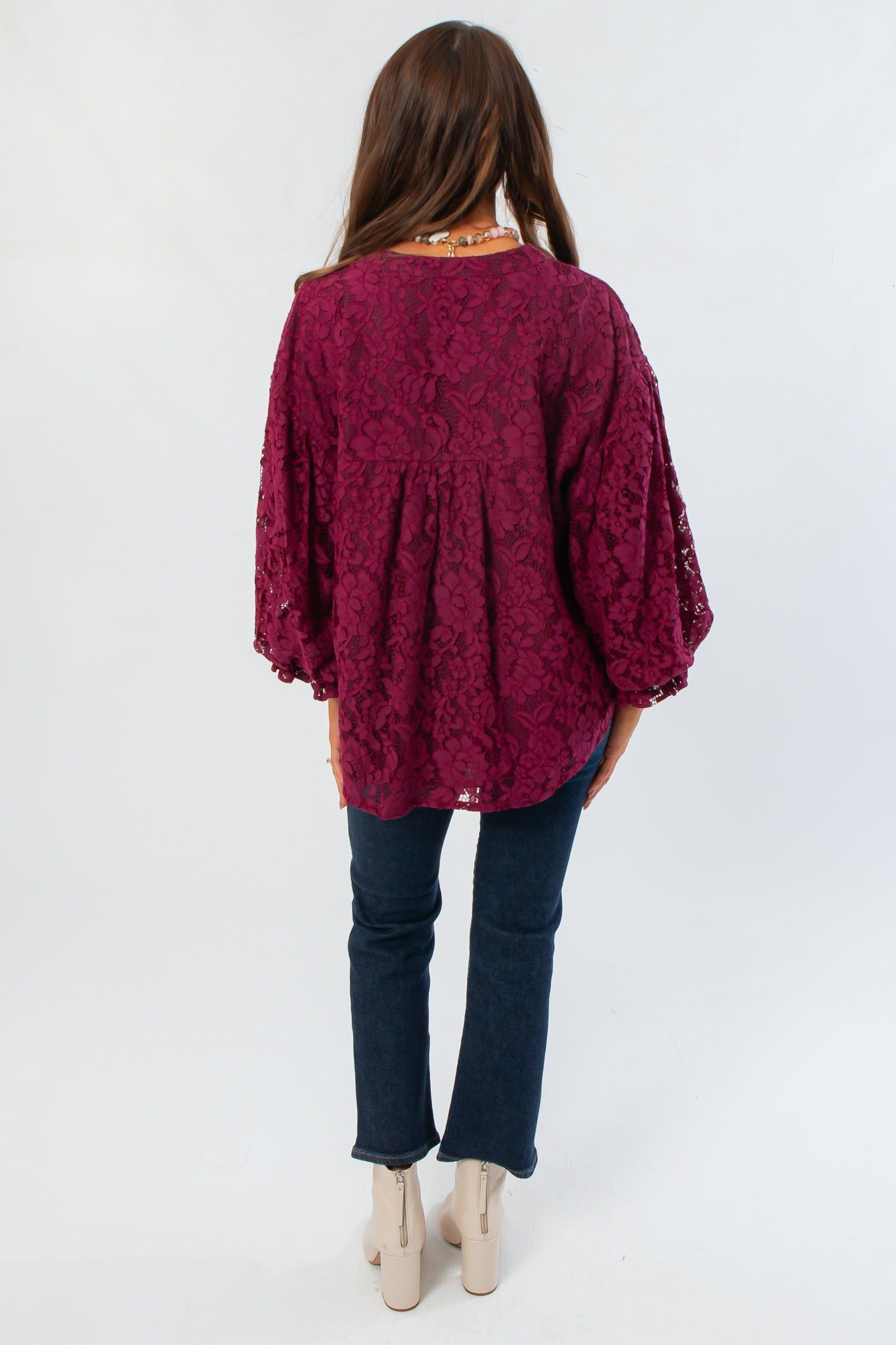 Back view of Jayne Wine Lace Bubble Sleeve Blouse showing gathered detailing and flowy silhouette, perfect for holiday and seasonal outfits.