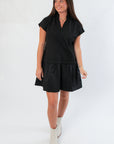 Model wearing THML Elise Black Suede Mini Dress with subtle V neckline and flowy silhouette, styled for effortless sophistication.