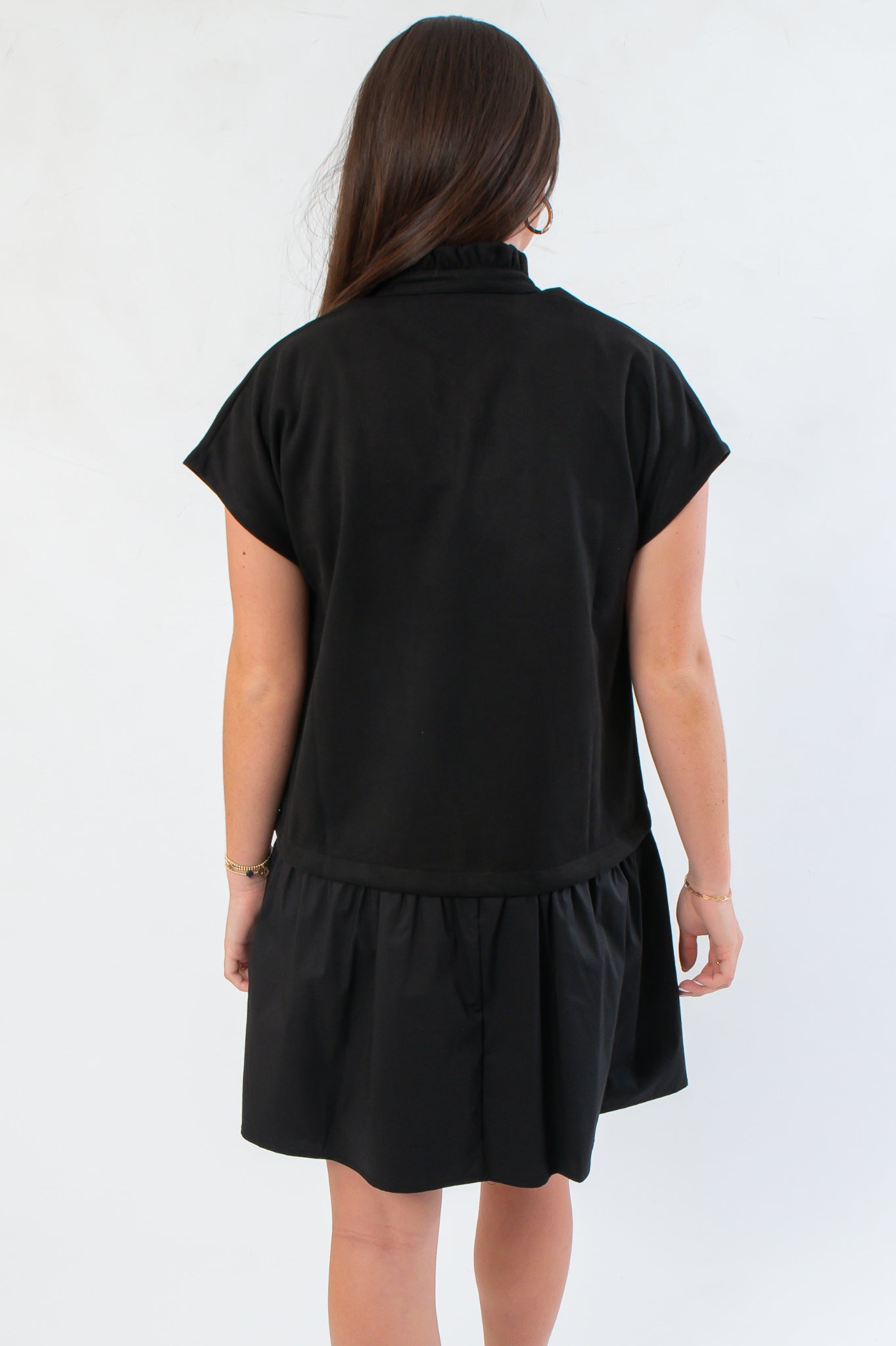 Back view of THML Elise Black Suede Mini Dress showcasing relaxed fit and drop waist design, ideal for versatile styling.