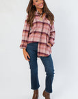 Magenta Haze Manny Plaid Flannel Shirt with long sleeves and relaxed fit, styled with dark denim jeans and brown ankle boots.