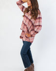 Side view of Magenta Haze Manny Plaid Flannel Shirt showcasing its relaxed silhouette and cozy texture for everyday wear.
