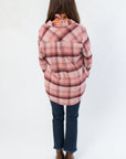 Back view of Magenta Haze Manny Plaid Flannel Shirt highlighting the plaid design and loose fit, ideal for layering in cooler seasons.