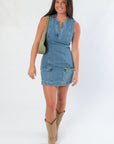 Steve Madden Denim Dress - Averi Blue Denim | Fashion. Sleeveless mini denim dress with front zip detail and utility pockets, styled with cowboy boots.
