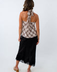 Black satin midi skirt paired with plaid halter top for chic fall outfit, black satin skirt with lace trim