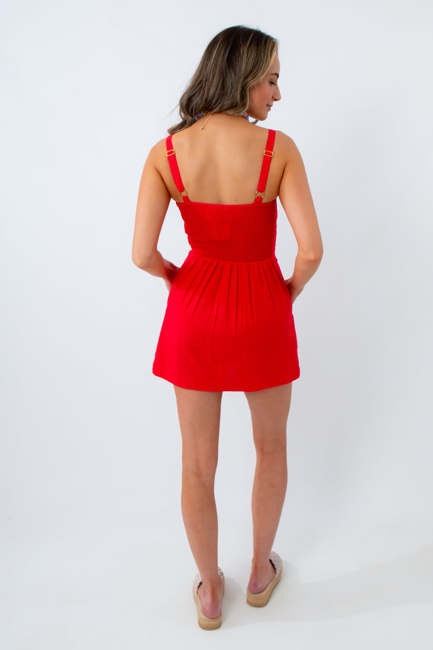 Woman wearing a red dress on a white background