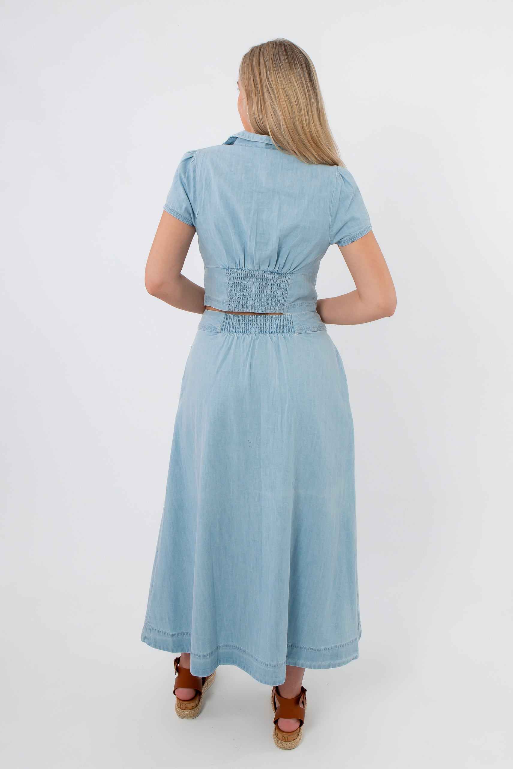 Light blue denim jumpsuit with smocked waist, spring-ready outfit for women