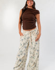Friday Feeling Brown Asymmetrical Top paired with floral wide-leg pants, a trendy and comfortable fall essential.