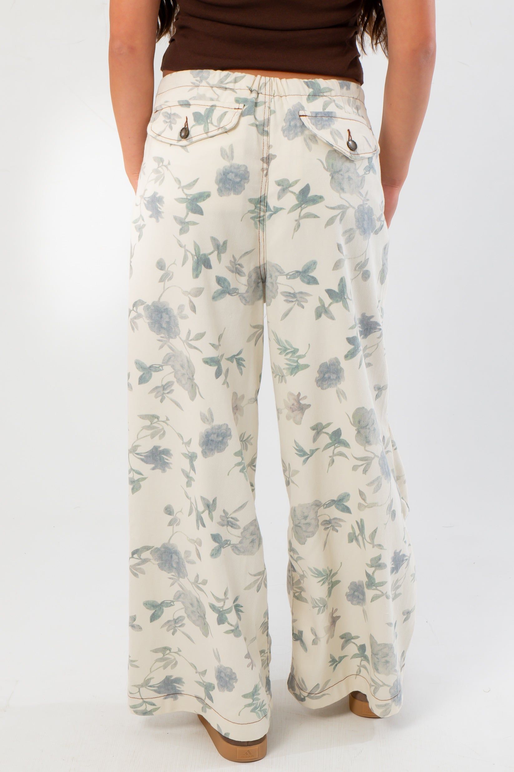 Back view of Weston Cream Floral Jeans showing rear pockets and all-over floral print, designed for a relaxed and stylish fit.