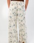 Back view of Weston Cream Floral Jeans showing rear pockets and all-over floral print, designed for a relaxed and stylish fit.