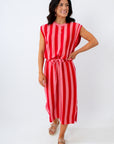 Woman wearing a red and white striped dress on a white background