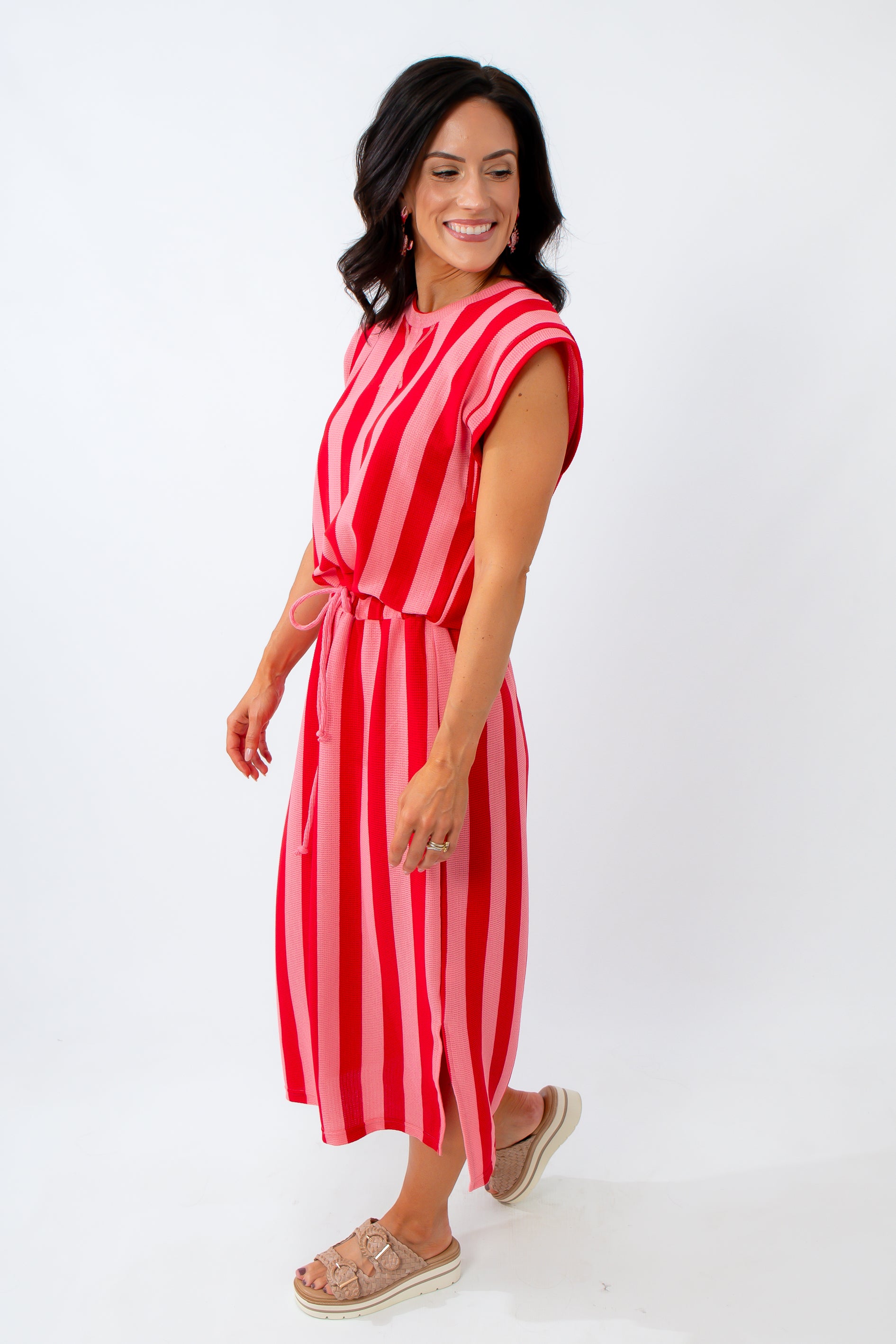 Woman wearing a red and white striped dress on a white background
