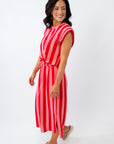 Woman wearing a red and white striped dress on a white background