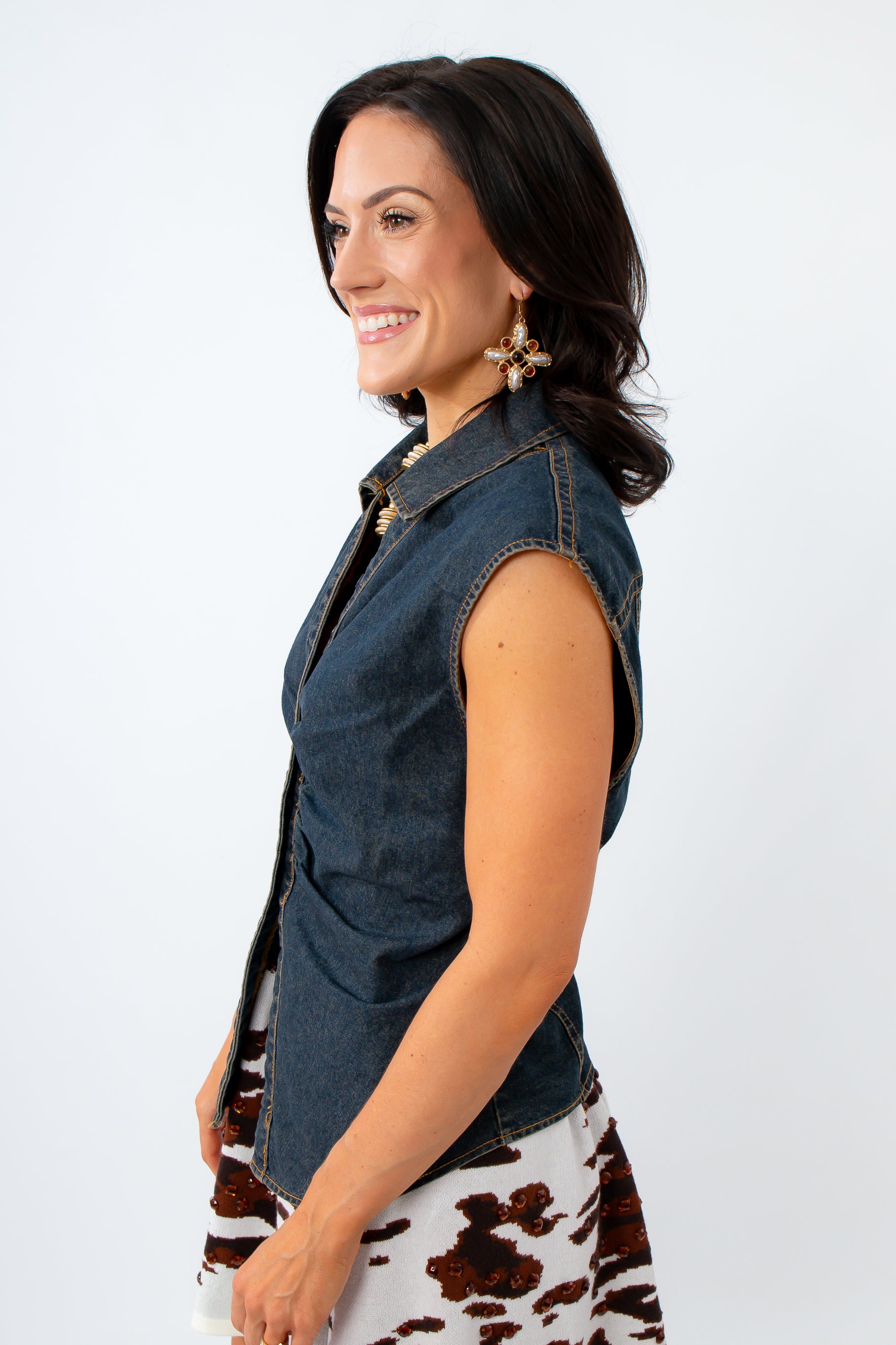Woman wearing a denim top with a queen of sparkles skirt
