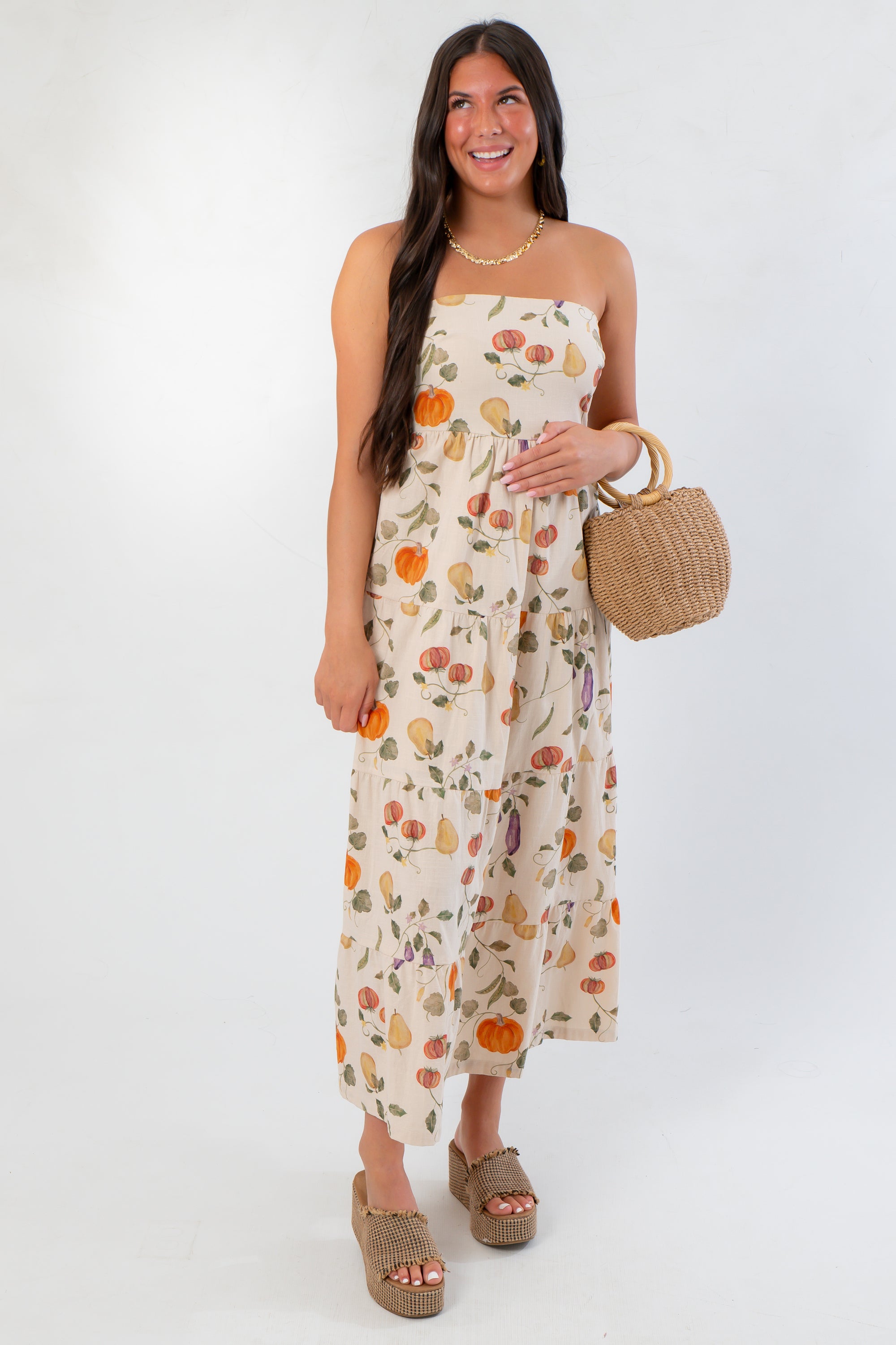 Heirloom Pumpkin Harvest Strapless Midi Dress - L Mae Boutique, styled with woven bag and sandals, perfect for festive fall occasions.