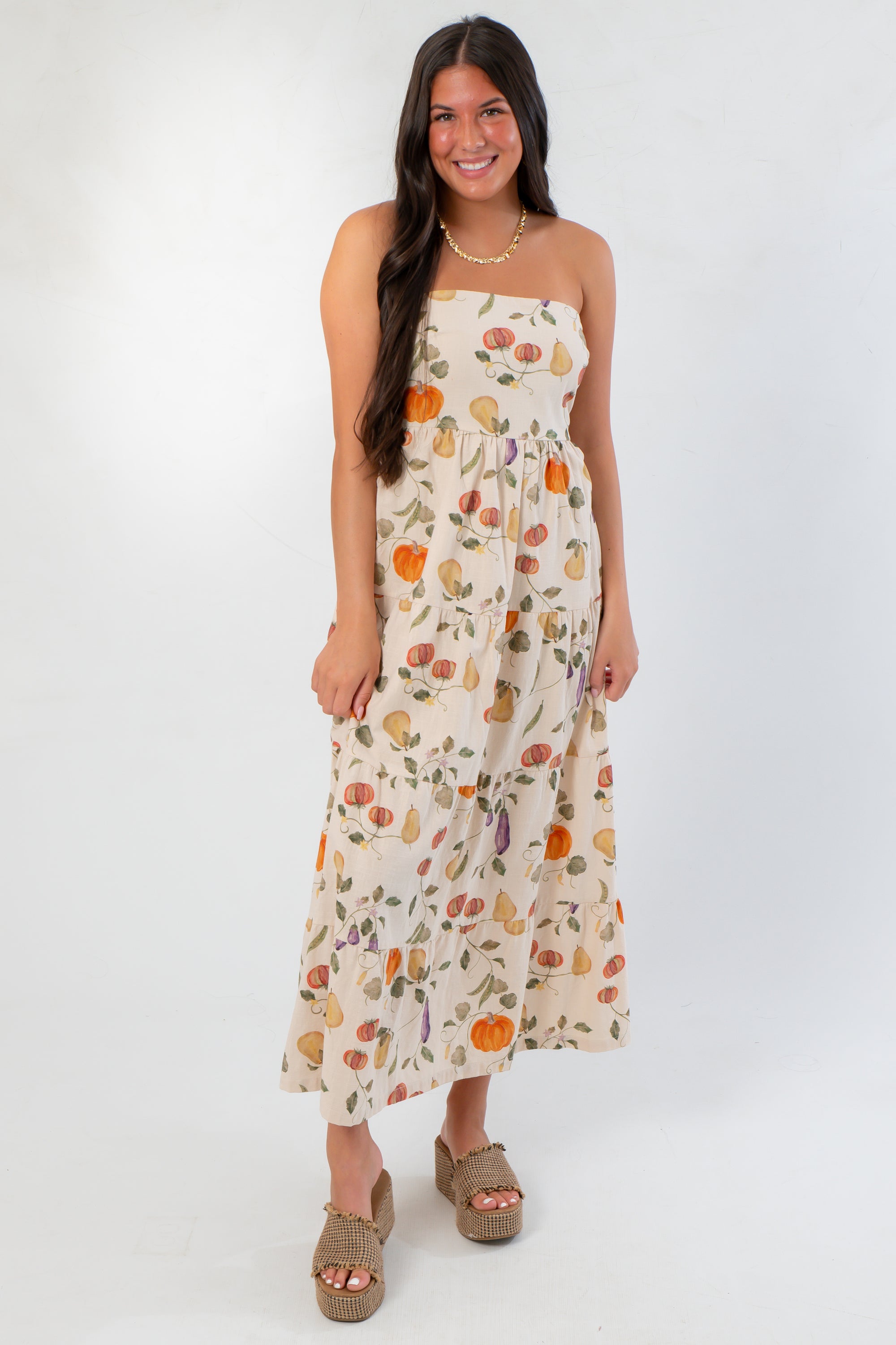 Front view of Heirloom Pumpkin Harvest Strapless Midi Dress featuring a tiered silhouette and vibrant pumpkin print for fall fashion.