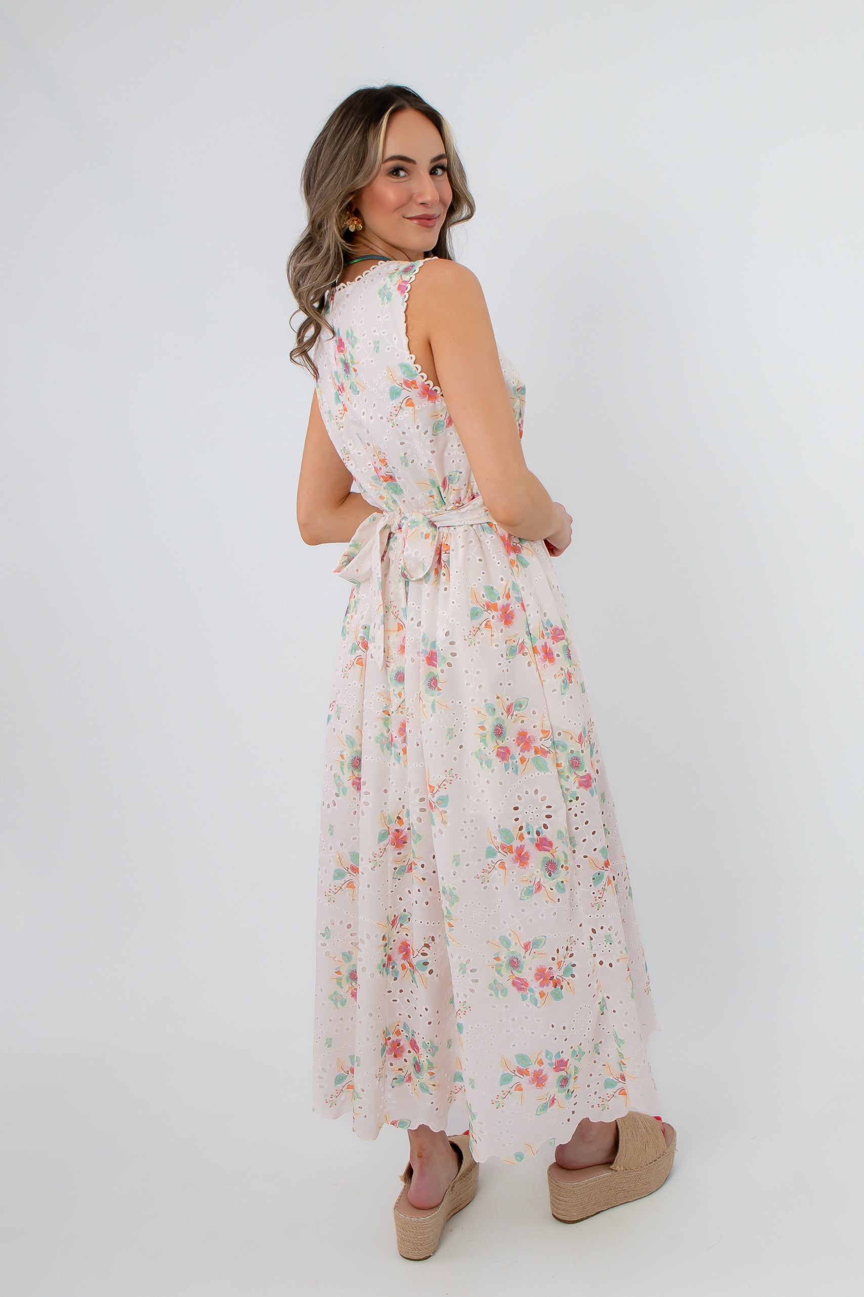 Side view of Spring Soirée White Floral Midi Dress with floral pattern and pockets