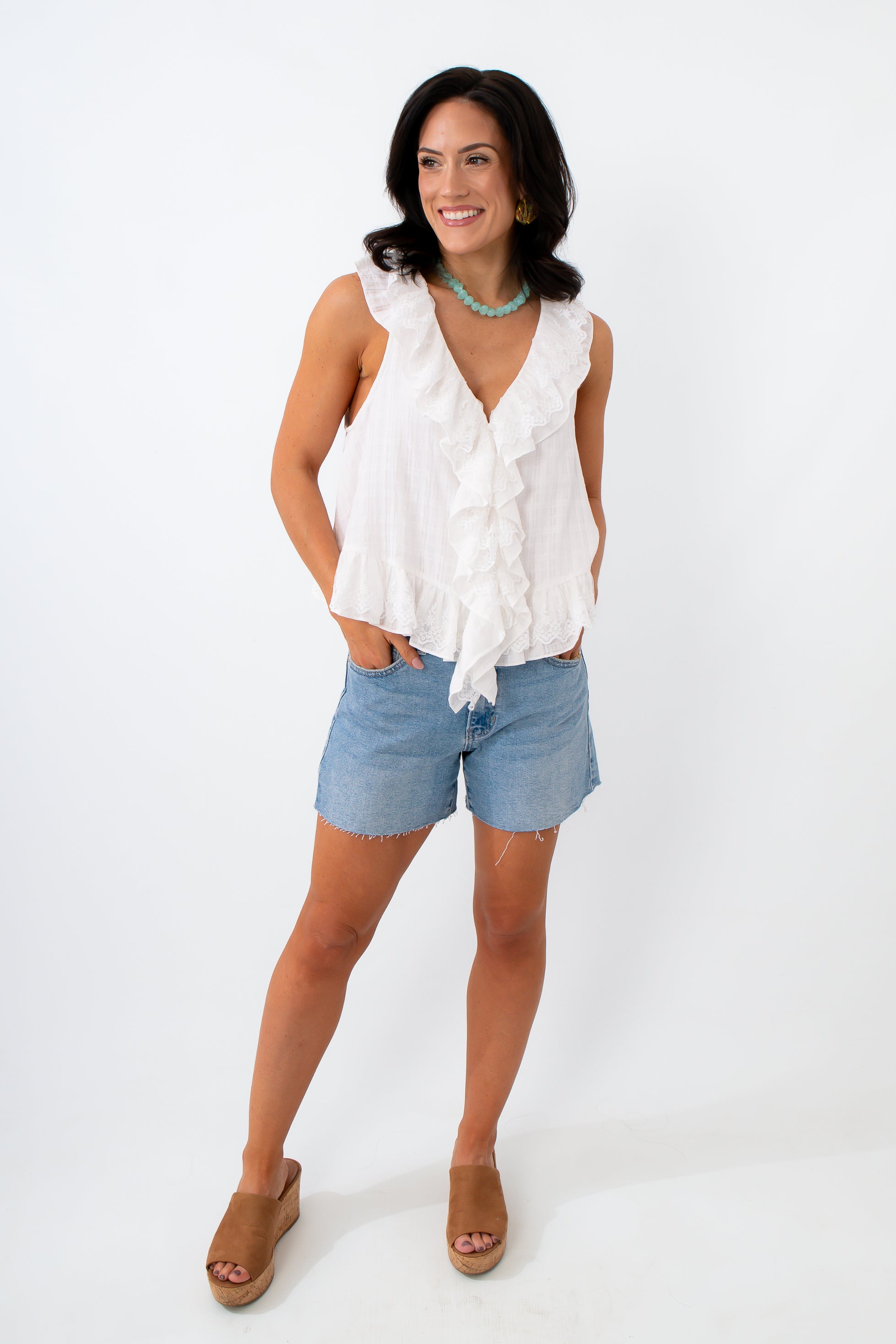 white ruffle summer top with colorful jewelry 