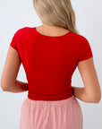 free people Person wearing a red top and striped pants on a white background