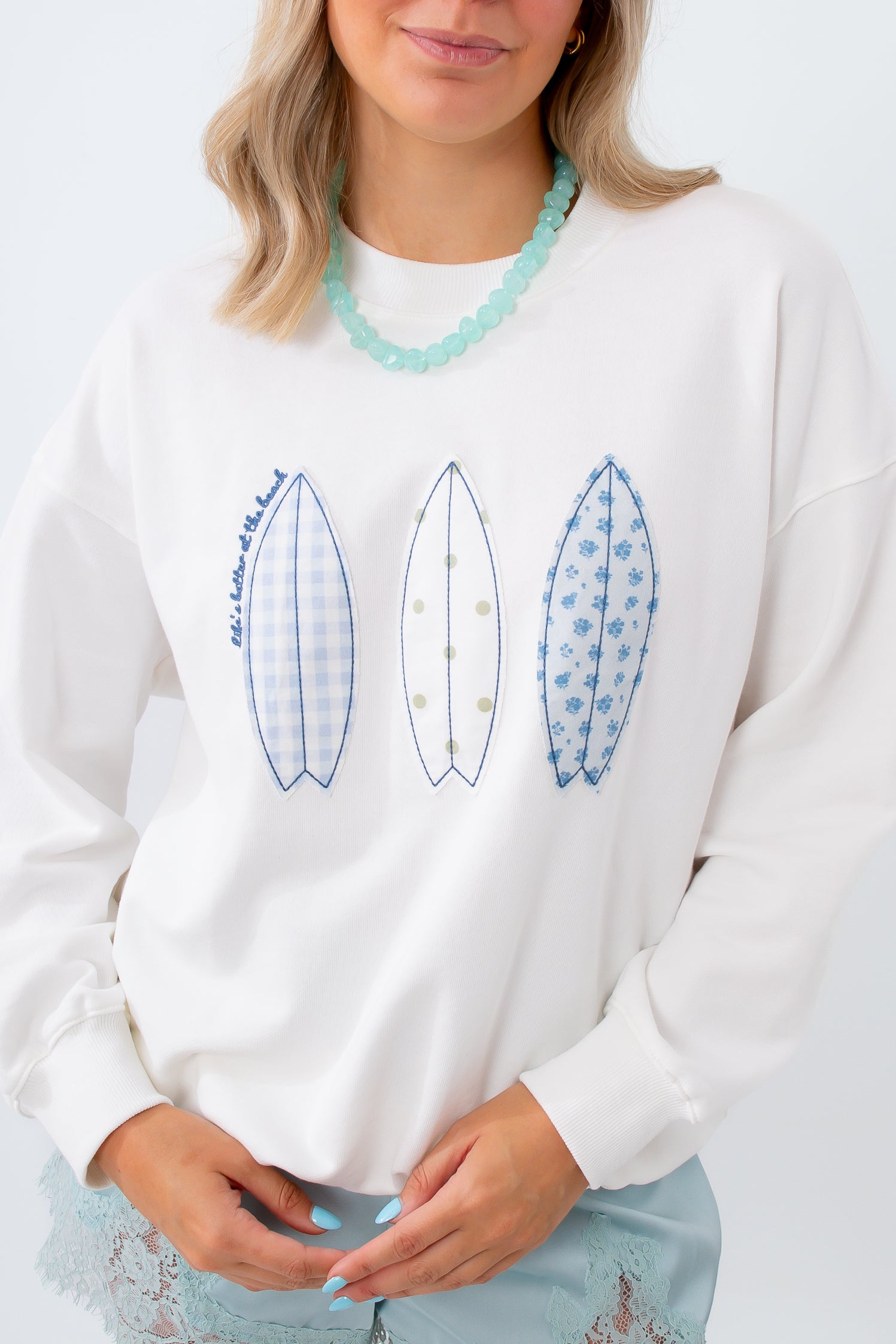 blue and white sweatshirt with surfboard pattern