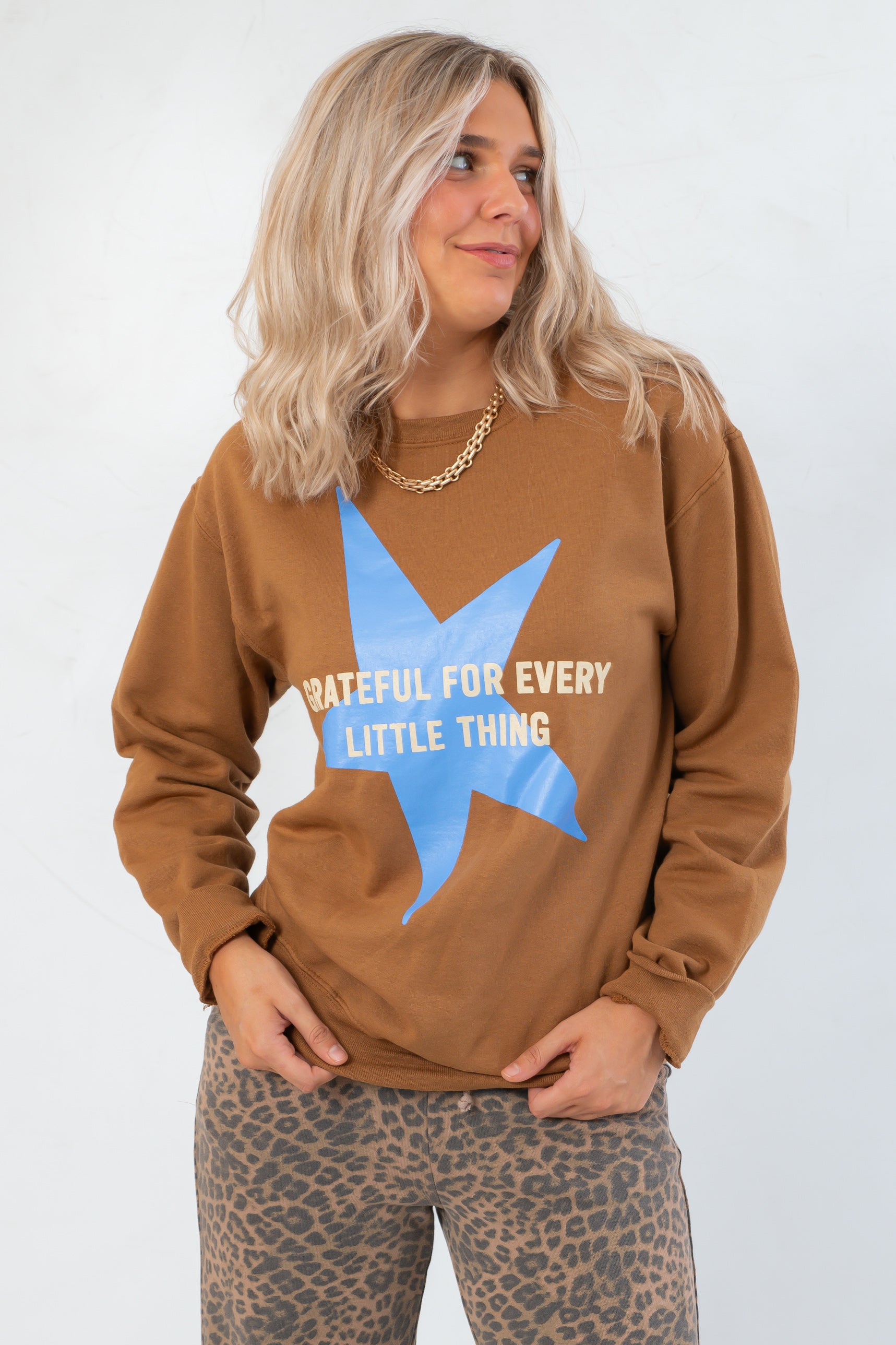 Thankful Cozy Knit Grateful for Everything Graphic Star Sweatshirt featuring bold blue star and white lettering, perfect for fall and Thanksgiving.