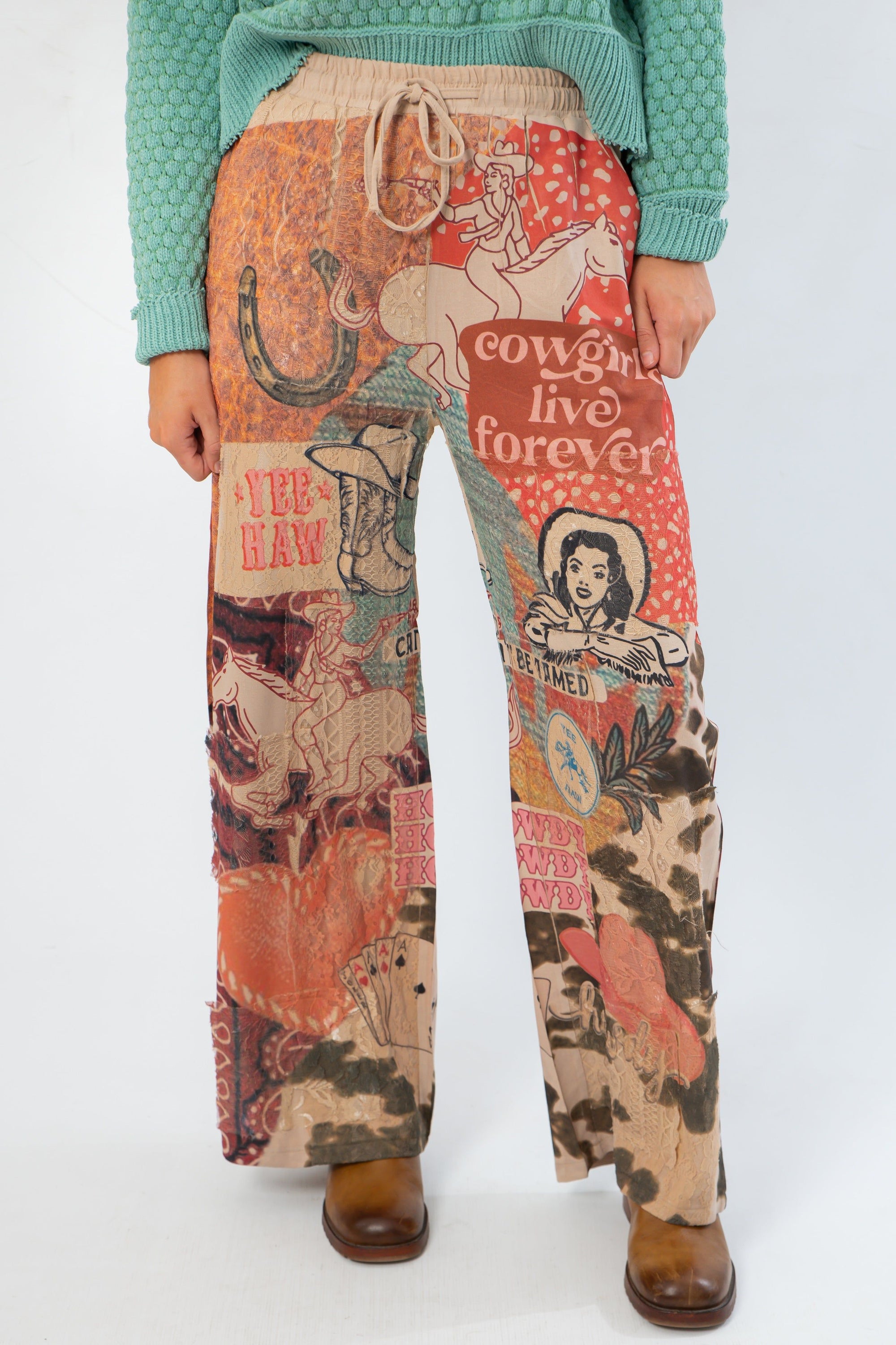 Close-up of Ori Howdy Drawstring Pants featuring bold western graphics, elastic waistband, and relaxed fit for casual wear.