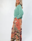 Side view of Ori Howdy Drawstring Pants with western illustrations and elastic drawstring waist, paired with casual knit top.