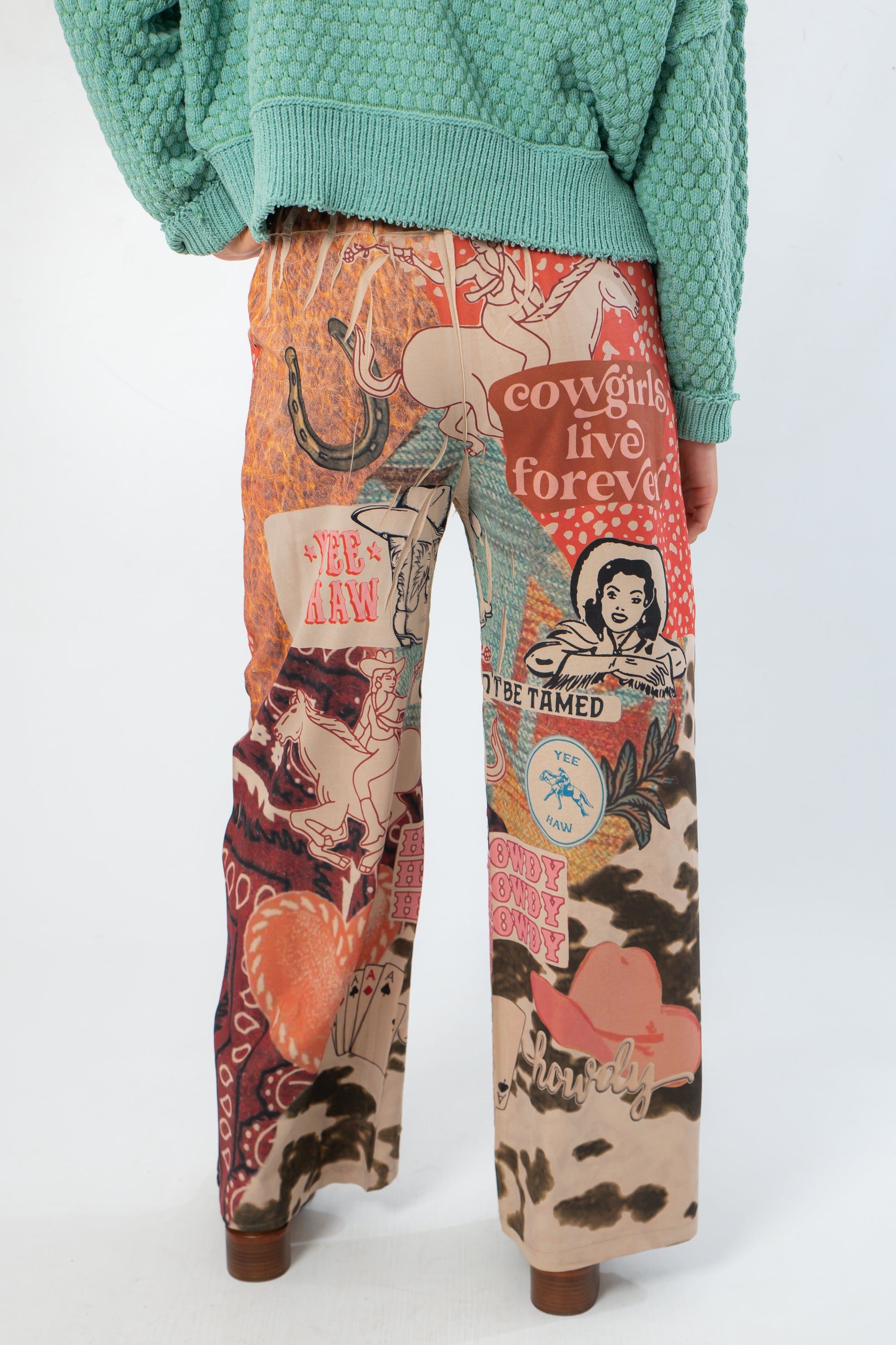 Back view of Ori Howdy Drawstring Pants showing detailed western graphics and comfortable elastic waistband for everyday wear.