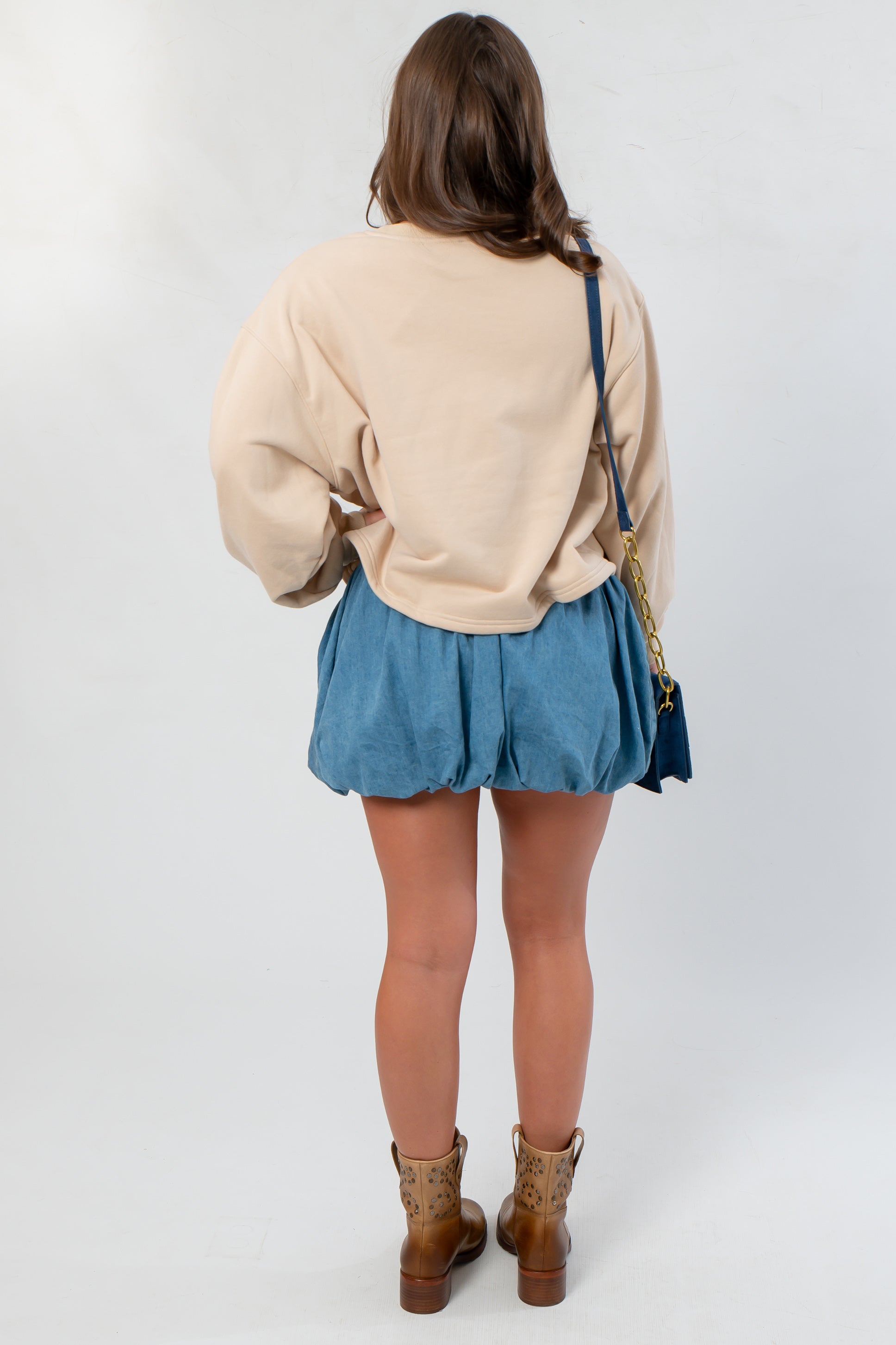 Back view of the Southern Chic “Y’all” Flocked Sweatshirt highlighting its soft neutral tone and loose silhouette, ideal for fall layering.
