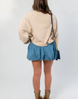 Back view of the Southern Chic “Y’all” Flocked Sweatshirt highlighting its soft neutral tone and loose silhouette, ideal for fall layering.