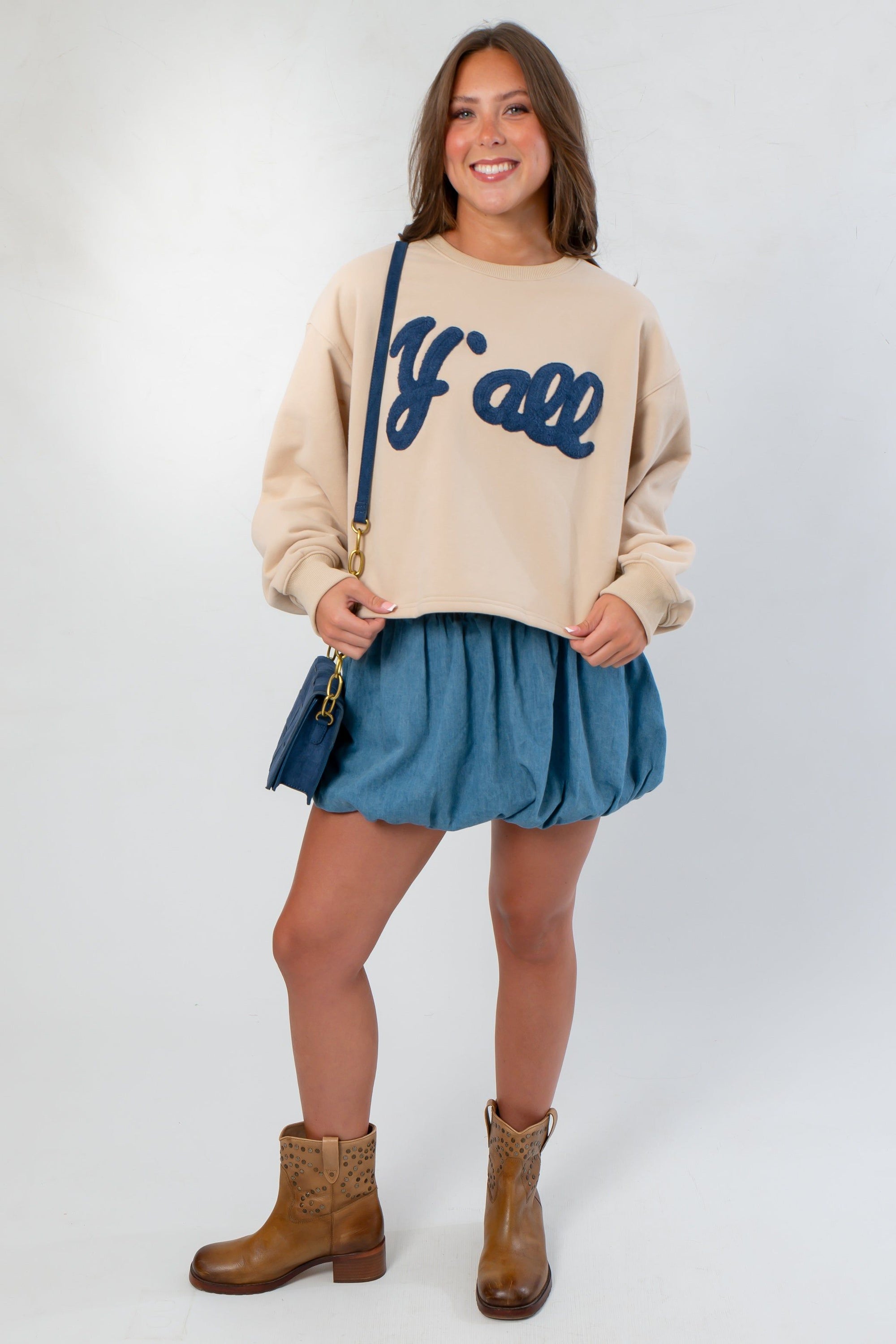 Front view of Denim Bubble Skort - Mini Skort paired with casual sweatshirt and boots, highlighting its high waist and bubble hem.
